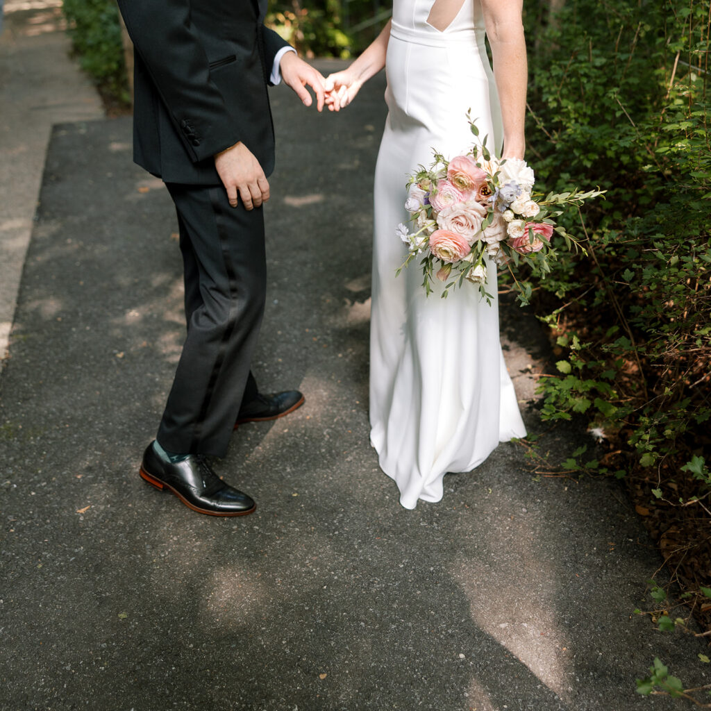 bride and groom holding hands on path in NYC at Celestine Wedding