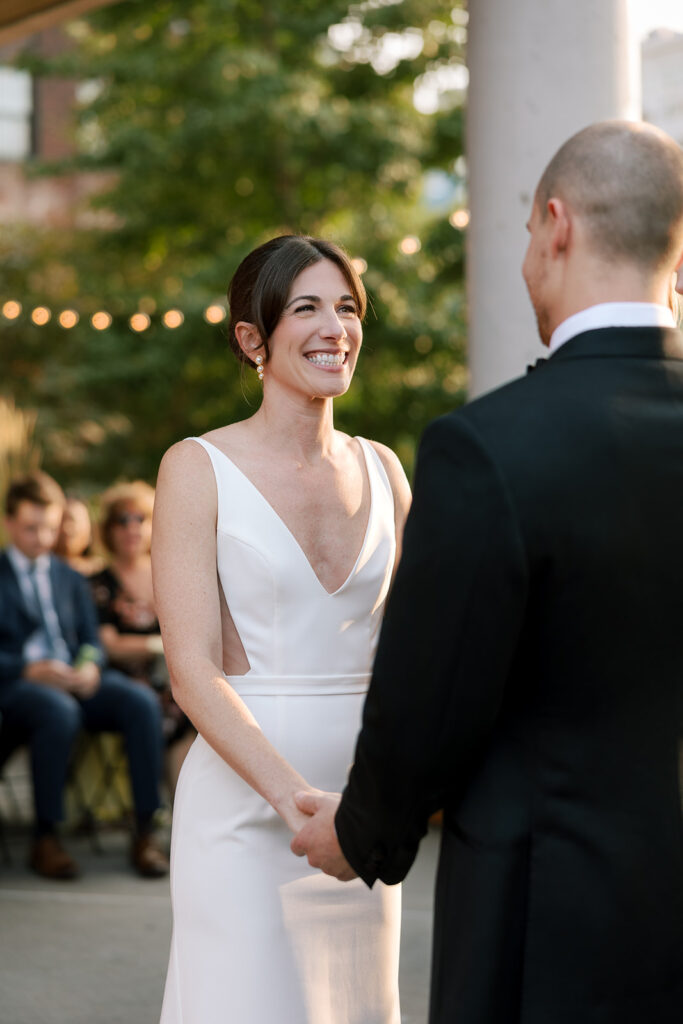 bride looking at groom smiling at ceremony at celestine wedding brooklyn