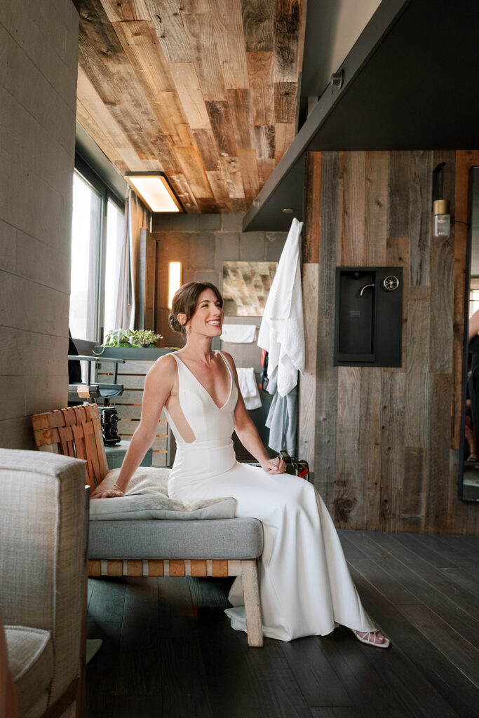 Bride sitting on sofa at Celestine Wedding