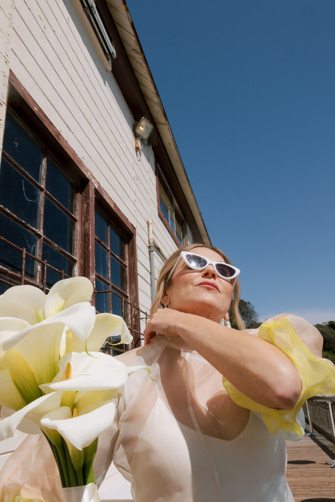 bride looking at the sun holding flowers at san francisco wedding
