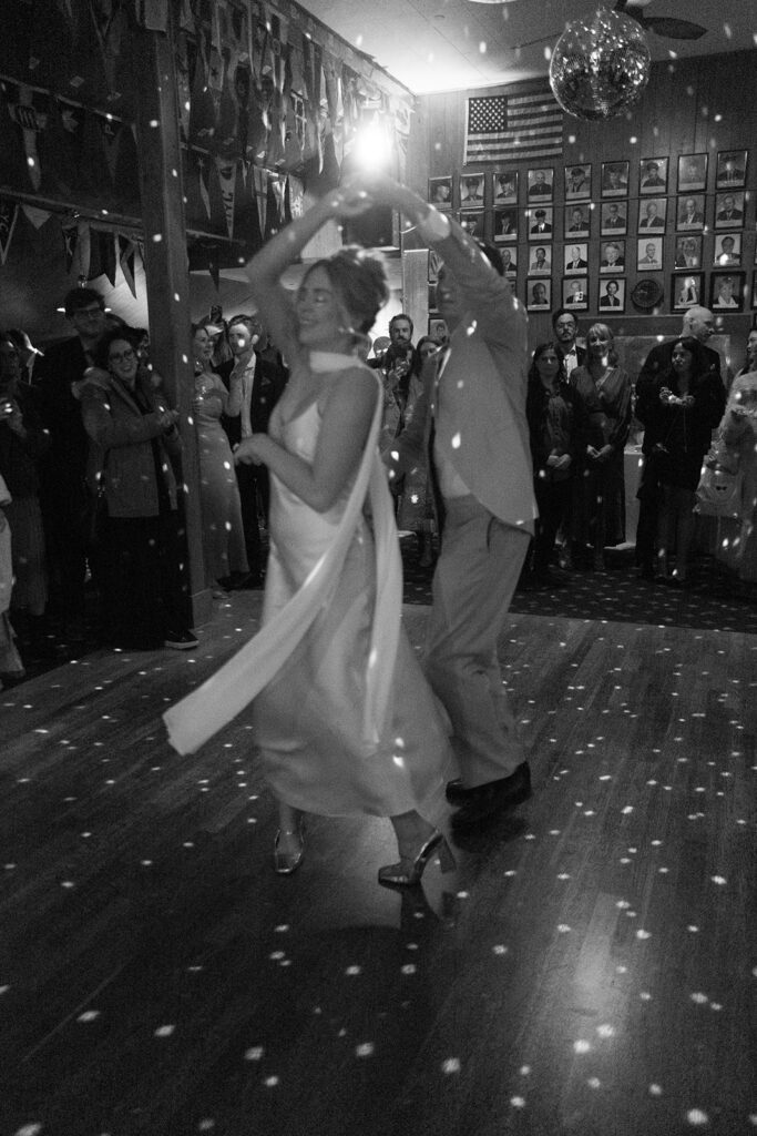 bride and groom dancing in dark with disco lights at travis marina wedding