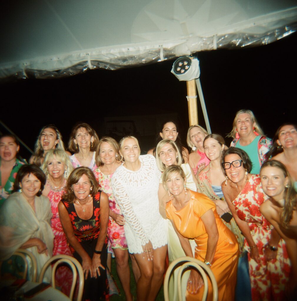 wedding guests wearing colorful dresses to show whalehead club photos