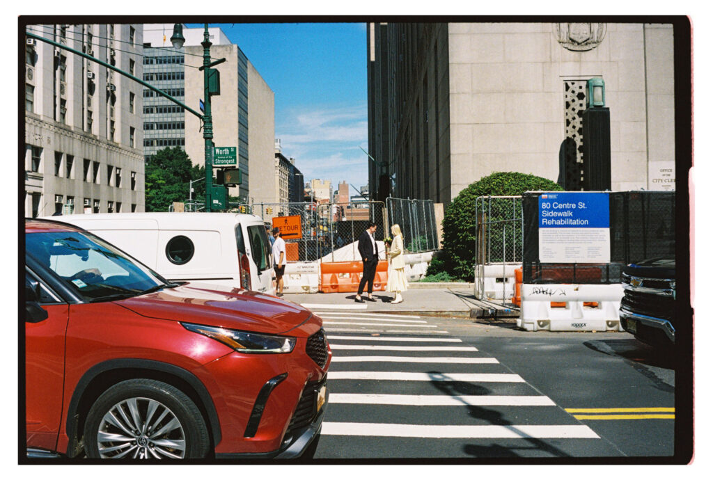 Couple walking up to elope in NYC at City Hall