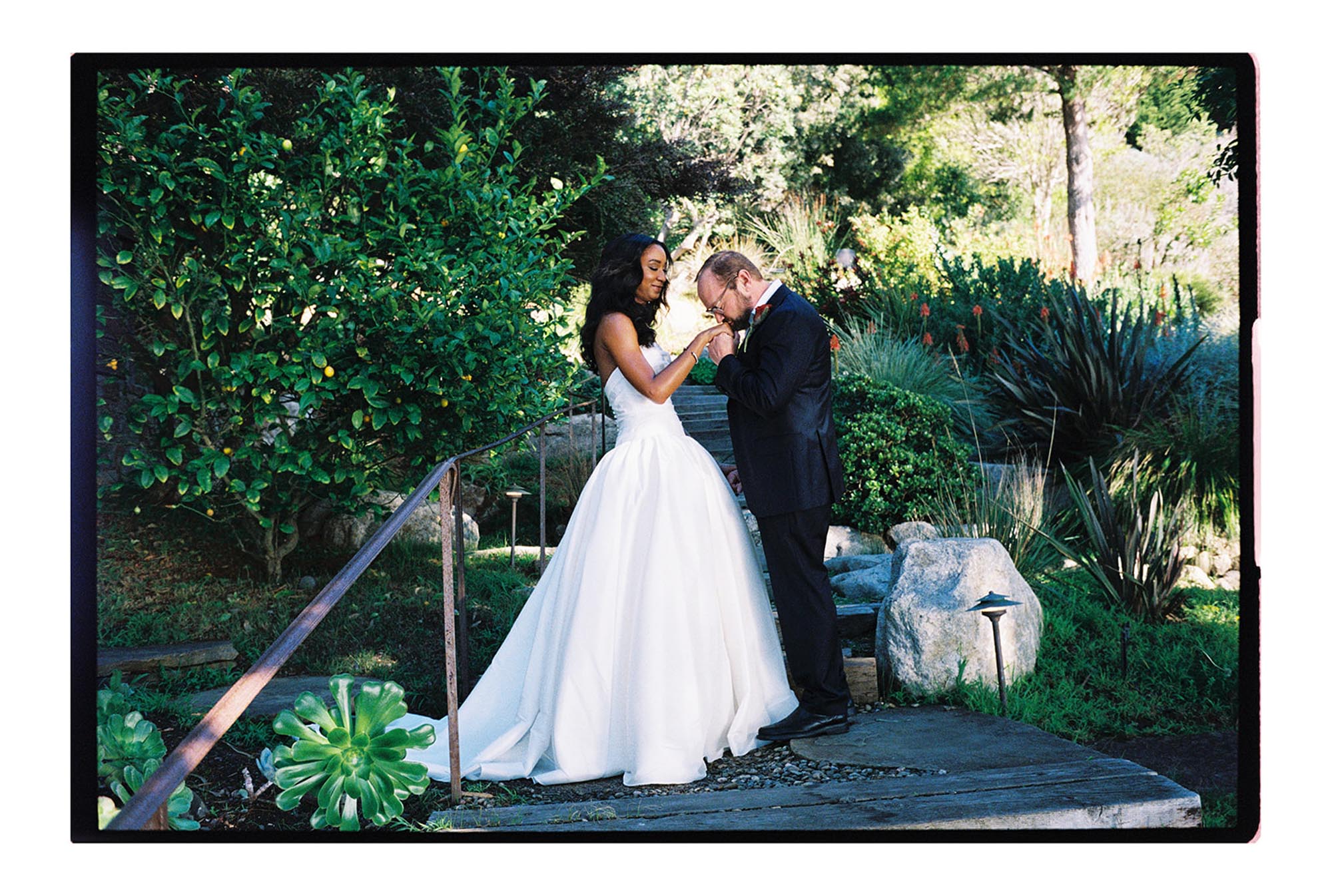 Groom kissing bride's hand at first look before big sur california wedding