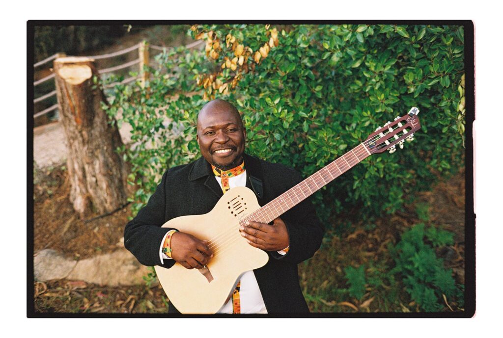 man playing guitar in a live band at big sur wedding