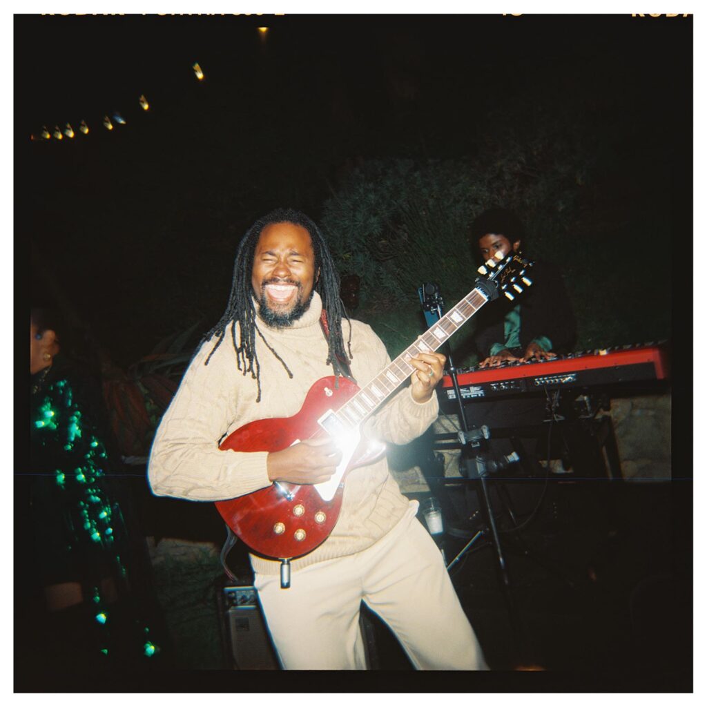 father of the bride playing guitar in a live band at big sur wedding