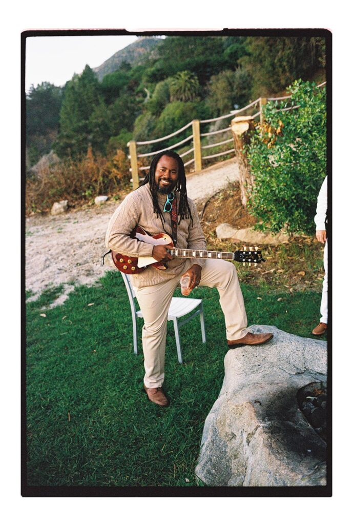 Father of bride playing guitar for big sur cliff wedding