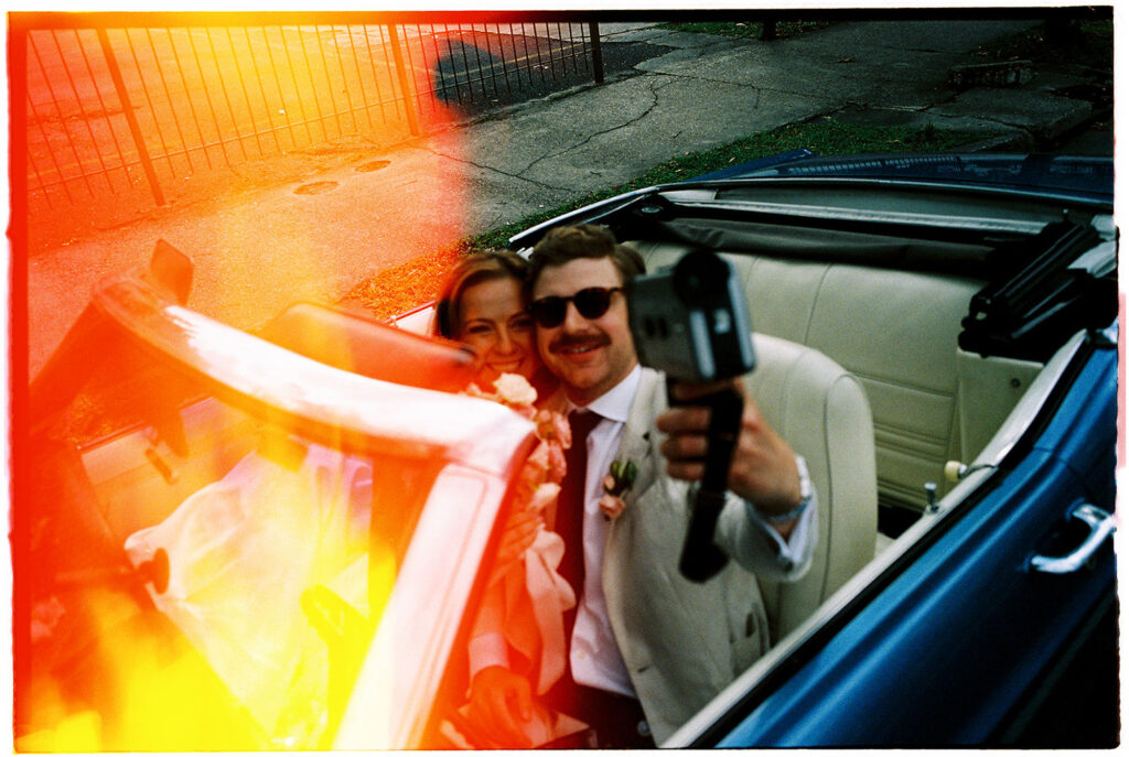 Bride and groom taking a selfie super 8 film after st mary's new orleans church Ceremony + reception at Brennan's